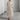 Eco-friendly oatmeal linen maxi dress in apricot color, featuring a minimalist loose fit design with an XL size. The dress showcases a round neck, long sleeves, and a flowing one-piece silhouette that reaches to the knees, suitable for formal events.