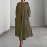 Eco-friendly oatmeal linen maxi dress in a minimalist loose fit, shown in green color in XL size. The dress features long sleeves, a relaxed shoulder line, and a flowing silhouette that extends to the ankles.