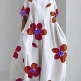 
An oversized floral dress with an eco-friendly design, featuring a white base with green leaf prints and orange accents, displayed on a hanger. The dress includes shoulder sleeves and a round neckline, suitable for plus-size figures, specifically in a 4XL size.