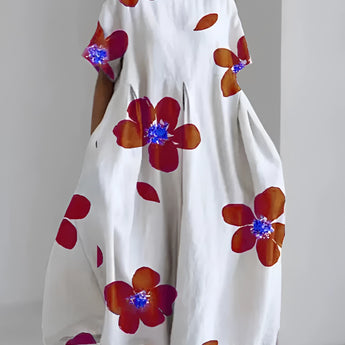 
An oversized floral dress with an eco-friendly design, featuring a white base with green leaf prints and orange accents, displayed on a hanger. The dress includes shoulder sleeves and a round neckline, suitable for plus-size figures, specifically in a 4XL size.