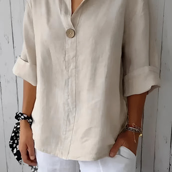Eco-friendly V-neck linen blouse in white, featuring a lightweight design ideal for summer. The blouse has long sleeves, a collar, and a relaxed fit at the waist.
