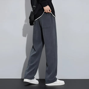 Men's stylish khaki corduroy pants paired with a grey blazer, showcasing a comfortable and fashionable outfit.
