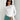 Electric blue women's cropped long sleeve crew neck top displayed on a model, highlighting the fit around the shoulders, arms, waist, and neck.
