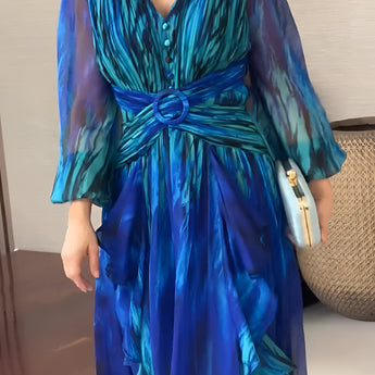 Elegant 2024 Women's Chiffon Maxi Dress in blue-green with sheer sleeves; features a wrap design and flowing one-piece silhouette.