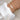 A hand wearing an elegant adjustable gold bracelet adorned with a pearl, displayed on a wrist, showcasing luxury jewelry.