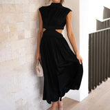Elegant black midi dress with a back cutout, featuring a fitted waist and knee-length hem. The dress has a stylish one-piece design suitable for evening wear.