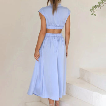 Elegant black midi dress with back cutout, designed for evening wear, featuring short sleeves and a fitted waist, showcasing a stylish and sophisticated silhouette.