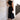 
A woman wearing an elegant black midi dress with a back cutout, featuring a fitted waist, short sleeves, and a modest neckline. The dress has a sophisticated and stylish design, suitable for evening wear.