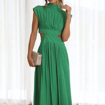
A stylish black midi dress featuring a distinctive back-cutout design, perfect for evening wear. The dress has a fitted waist, short sleeves, and a modest neckline, accentuating the shoulders and arms. The model is standing, showcasing the elegant silhouette of the one-piece garment.