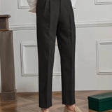 Elegant beige high-waisted pleated trousers for women, designed for office wear, shown in a full-body view highlighting the waist, thigh, and knee areas.