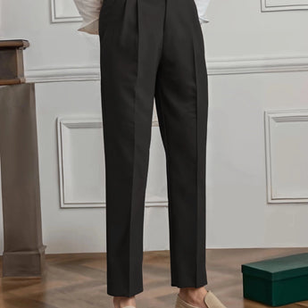 Elegant beige high-waisted pleated trousers for women, designed for office wear, shown in a full-body view highlighting the waist, thigh, and knee areas.