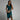 Elegant green cocktail dress in 3XL, featuring a sleeveless V-neck wrap design with a knee-length hemline. The dress is displayed on a smiling model, highlighting the waist and collar areas.