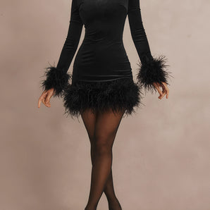 Elegant black feather trim long sleeve mini dress worn by a woman, showcasing her legs and shoulders, perfect for party wear.