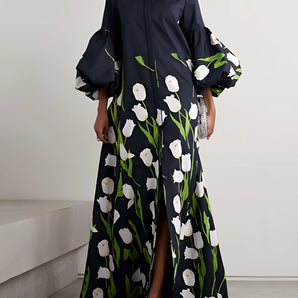 Elegant black floral long sleeve maxi dress with a fitted waist, showcasing a sophisticated design.