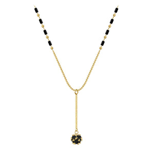 Elegant black gemstone pendant necklace with gold chain, featuring a circular symmetrical design.
