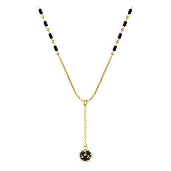 Elegant black gemstone pendant necklace with gold chain, featuring a circular symmetrical design.