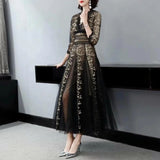 Elegant black and gold embroidered lace evening gown maxi dress with long sleeves and a fitted waist, showcasing intricate fashion design elements.