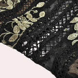 Elegant black and gold embroidered lace evening gown maxi dress featuring intricate motifs and patterns, with a fitted waist and long sleeves.