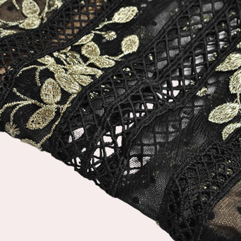 Elegant black and gold embroidered lace evening gown maxi dress featuring intricate motifs and patterns, with a fitted waist and long sleeves.