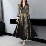 Elegant black and gold embroidered lace evening gown maxi dress featuring intricate lace detailing, fitted waist, elegant neckline, and full-length sleeves, modeled by a fashion model.