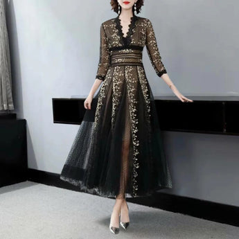 Elegant black and gold embroidered lace evening gown maxi dress featuring intricate detailing on the waist, long sleeves, and a sophisticated neckline.