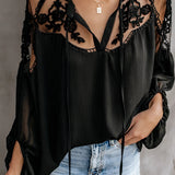 Elegant black lace blouse featuring sheer sleeves and detailed floral embroidery, highlighting fashion-forward design with a focus on neck and shoulder areas.