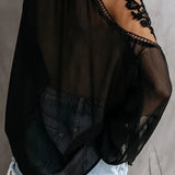 Elegant black lace blouse featuring sheer sleeves and intricate floral embroidery, highlighting the shoulder and neck area. The blouse is designed with a focus on fashion, emphasizing the waist and overall fit.