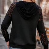 Elegant black sweater with lace sleeves, featuring a stylish design suitable for women's fall fashion. The top showcases intricate lace detailing on the sleeves and a comfortable fit, highlighting the neckline and shoulder area.
