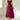 Elegant black midi dress with a square neckline, featuring short sleeves and convenient pockets. The dress has a fitted waist and a flowy skirt, suitable for day wear or casual occasions.