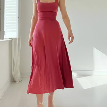Elegant black midi dress with a square neckline and pockets, suitable for both casual and formal occasions.