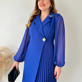 Elegant black pleated long sleeve mini dress with a fitted silhouette, featuring a modest neckline and tailored sleeves, perfect for an office chic look.
