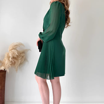 Elegant black pleated mini dress with long sleeves, featuring a chic office-ready style.