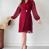 Elegant black pleated long sleeve mini dress with a fitted waist and knee-length hem, designed for an office chic look.