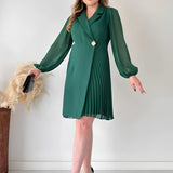 Elegant green pleated long sleeve mini dress with a chic design, featuring a comfortable fit suitable for office wear, shown on a model wearing complementary footwear.