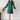 Elegant green pleated long sleeve mini dress with a chic design, featuring a comfortable fit suitable for office wear, shown on a model wearing complementary footwear.