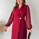 Elegant black pleated long sleeve mini dress with a collar and tailored waist, styled for an office chic look. The dress features a sleek design, covering the shoulders and arms, and includes a coat-like appearance at the top.
