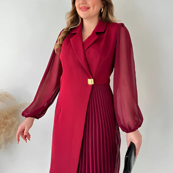 Elegant black pleated long sleeve mini dress with a collar and tailored waist, styled for an office chic look. The dress features a sleek design, covering the shoulders and arms, and includes a coat-like appearance at the top.