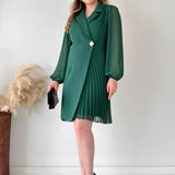Elegant black pleated mini dress with long sleeves and a sophisticated collar, designed for an office chic look.