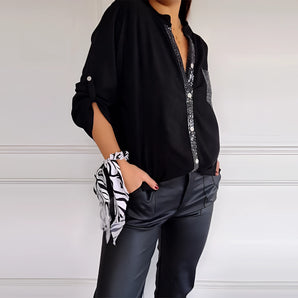 Elegant black satin blouse with crystal embellishments, featuring long sleeves, a tailored fit around the waist, and a subtle sheen, perfect for evening wear.