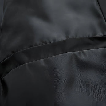 Elegant black silk fabric with a smooth, glossy texture displayed in a close-up shot, showcasing subtle patterns and shades, resembling the sheen of luxury textiles.