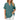 Woman wearing an elegant dark green V-neck linen blouse with short sleeves, showcasing casual summer style.
