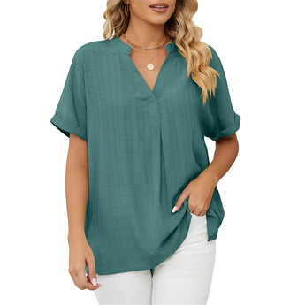 Woman wearing an elegant dark green V-neck linen blouse with short sleeves, showcasing casual summer style.