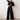 Elegant black wide-leg palazzo jumpsuit with long sleeves, high waist, and boat neck, shown in size 2XL.