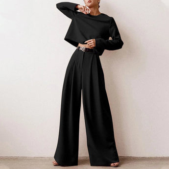 Elegant black wide-leg palazzo jumpsuit with long sleeves, high waist, and boat neck, shown in size 2XL.