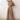 Elegant black wide-leg palazzo jumpsuit with long sleeves, high waist, and boat neck, shown in a khaki color, size 2XL.