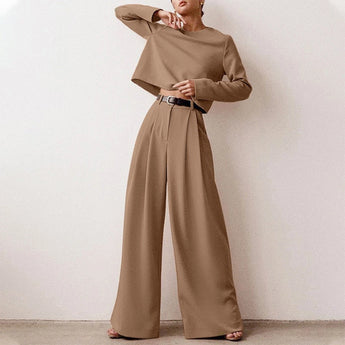 Elegant black wide-leg palazzo jumpsuit with long sleeves, high waist, and boat neck, shown in a khaki color, size 2XL.