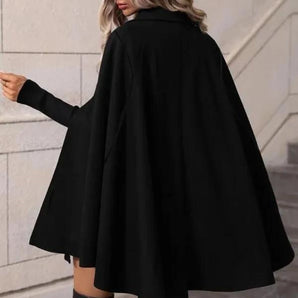 Elegant black women's hooded cape coat with a stylish winter design featuring shoulder-length sleeves and a sleek silhouette, ideal for fashionable and cozy winter wear.