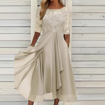 
An elegant blue lace top evening dress featuring a high-low skirt. The dress is in a beige color and is available in a 3XL size. The design includes intricate lace detailing on the shoulders and neckline, with long sleeves and a defined waist.