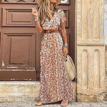 Elegant blue paisley bohemian maxi dress featuring high slits, modeled in a standing position showcasing the garment's flowy design, with focus on its neckline, sleeves, and waist details.