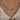 A woman's hand gently touching her neck, wearing an elegant bridal pearl choker with a gold heart charm.